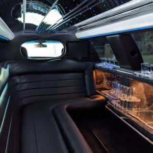 Explore the plush interior of a luxury limousine featuring ambient lighting and comfortable seating.